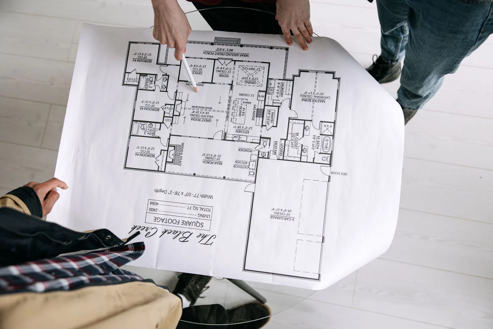 Personen bei der Prüfung eines Bauplans, Symbolbild